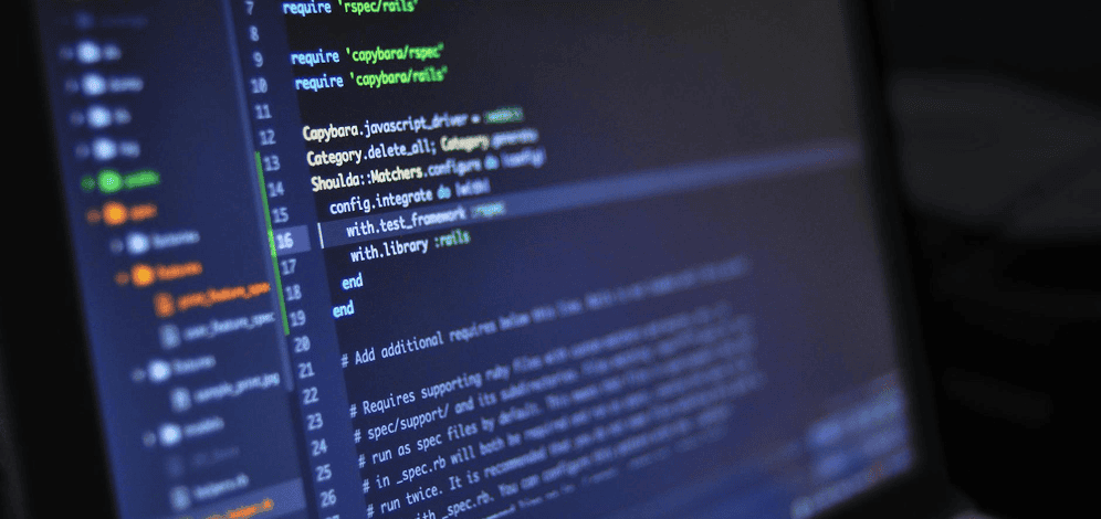 A computer screen displays lines of code in a text editor, showing syntax highlighting and file navigation on the left side.